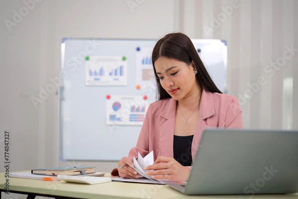 Fototapeta Business accounting woman counting on calculator working on financial document in hands closeup. Bookkeeping concept