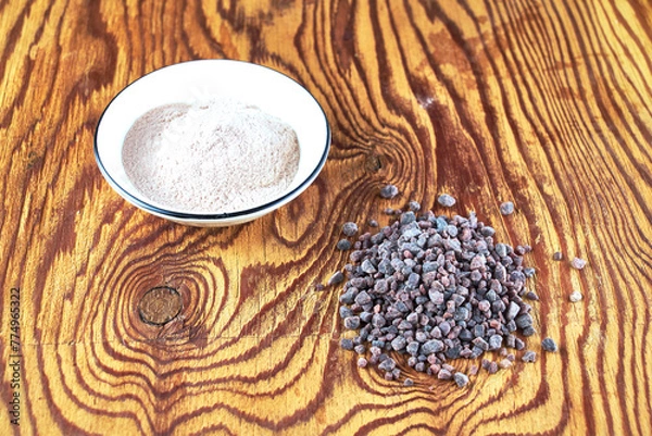 Fototapeta Black Kala namak salt in a salt shaker and on a wooden table