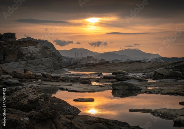Obraz Sunset time at the coastline of Badouzi, sunlight shines on the water with gorgeous rocks by the side, in Keelung city, Taiwan.