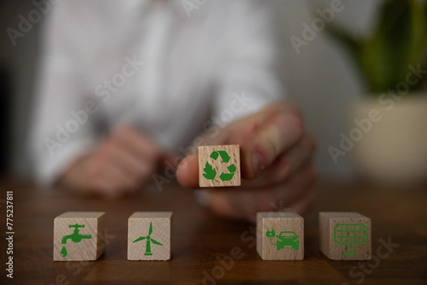 Fototapeta Green and eco building concept. wooden cubes with green building symbols on the natural background. LEED certification. Leadership in Energy and Environmental Design. Sustainable building.
