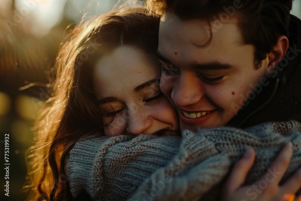 Fototapeta A man and a woman hugging and smiling with their eyes closed