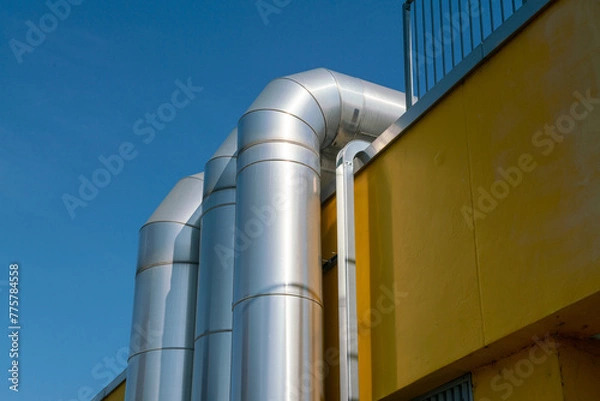 Fototapeta ventilation system pipes in the building, detailed detail with elements that reflect the warm summer sunlight. air conditioning and ventilation system incentives