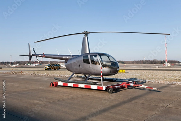 Obraz helicopter on the airfield at airport in front of blue sky