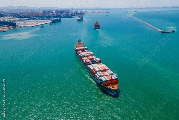 Obraz the image provides a stunning aerial view of a bustling cargo ship port, where massive vessels dock and unload their precious cargo.
