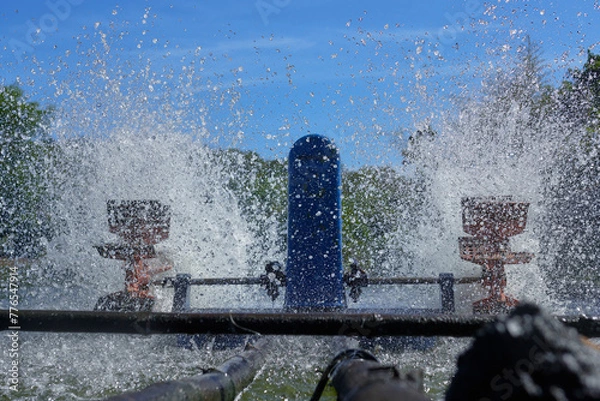 Fototapeta Paddle Wheel Aerator: Revitalizes a lake or pond by churning up water and increasing oxygen levels in aquatic flora and fauna