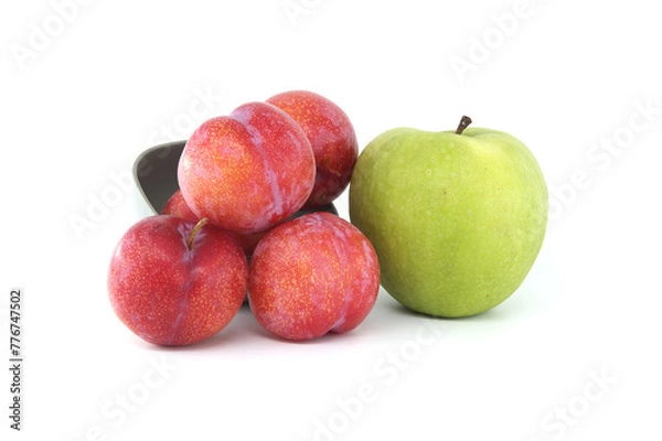 Fototapeta Red plums and green apple isolated on white background