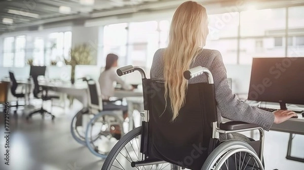 Fototapeta Professional businesswoman in wheelchair smiling and working in modern office environment