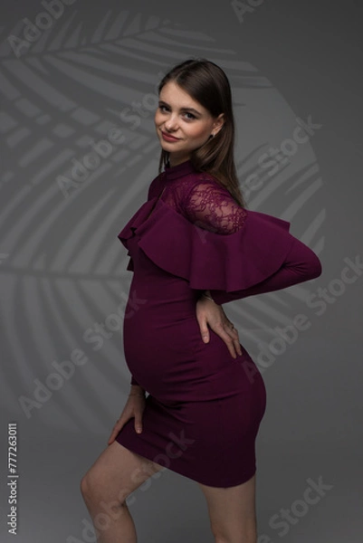 Obraz fashion pregnant model posing in studio, pregnant woman stands on a grey background, studio shoot