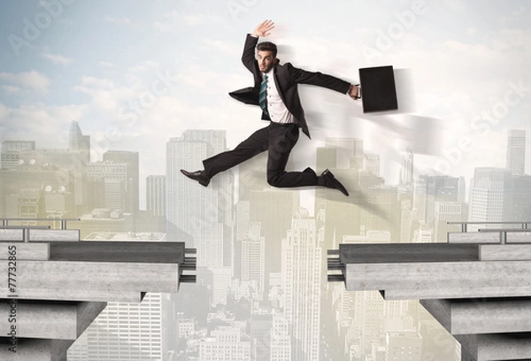 Fototapeta Energetic business man jumping over a bridge with gap