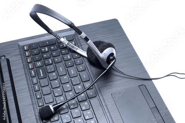 Obraz Headset lying on a laptop computer keyboard