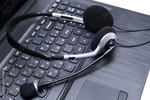 Obraz Headset lying on a laptop computer keyboard