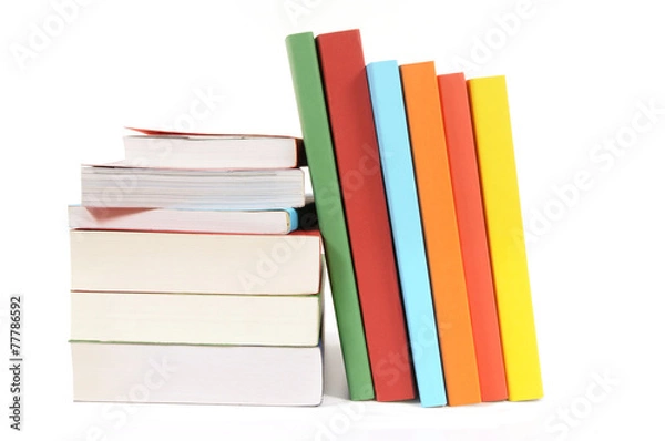 Fototapeta Collection of colorful paperback books in a row line with small stack isolated white background photo