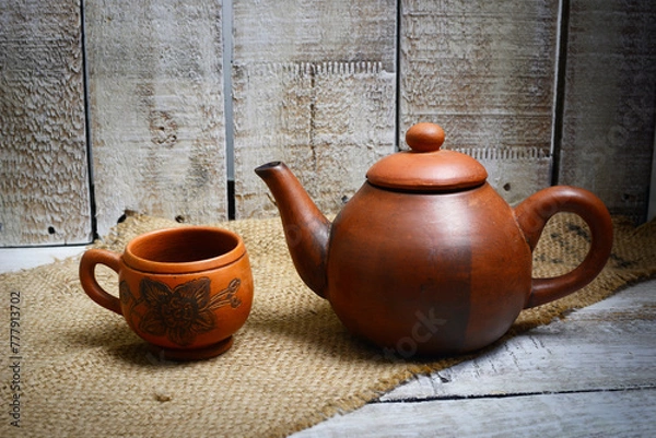 Fototapeta Teapots, teapots, places to brew and drink tea from terracotta, made traditionally, wooden background and natural wicker