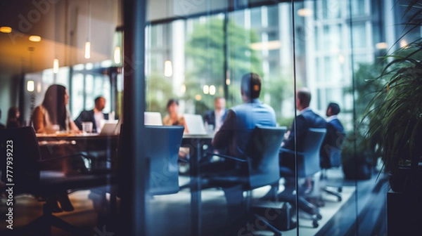 Obraz Blurry Office Meeting Through Glass Wall: Focusing on Corporate Teamwork and Workplace Dynamics.