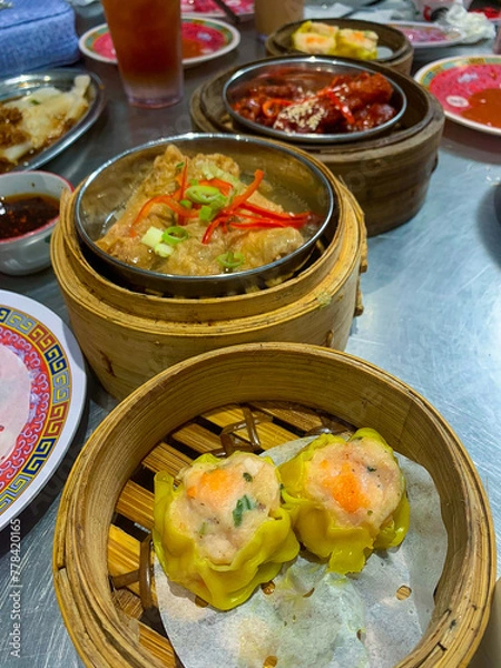 Obraz Delicious Chinese Foods, Dim Sum, Chicken Feet, and Tofu on Bamboo Tray