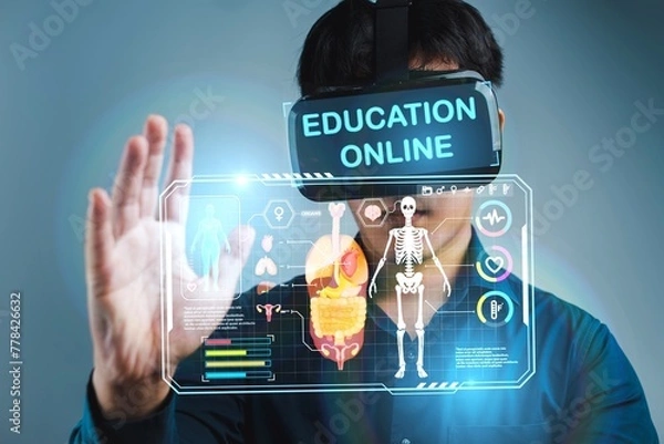 Fototapeta A man is wearing a virtual reality headset and is interacting with a 3D image of a skeleton. The image is titled "Education Online" and he is related to a virtual learning environment
