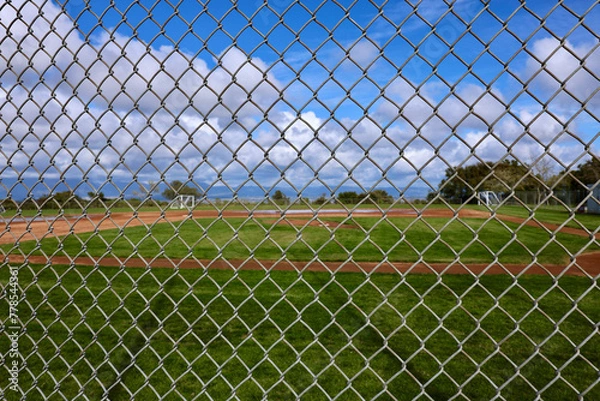 Obraz baseball field viewed through a chainlink fence