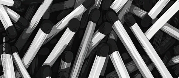 Fototapeta A monochrome photo featuring a closeup shot of a pile of matches with a pattern resembling a grille. The parallel arrangement gives a unique automotive tirelike appearance