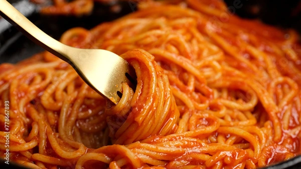 Obraz Stirring spaghetti with tomato sauce