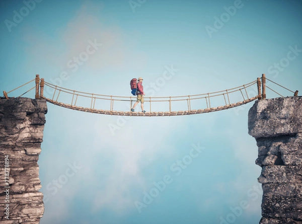 Fototapeta Mężczyzna spacerujący po wiszącym moście linowym. Koncepcja podróży