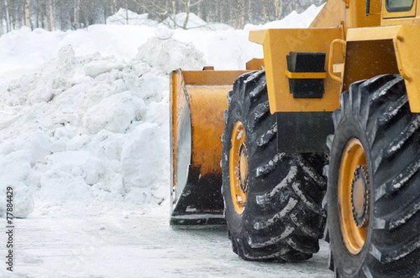 Obraz The bulldozer cleans the road after a blizzard