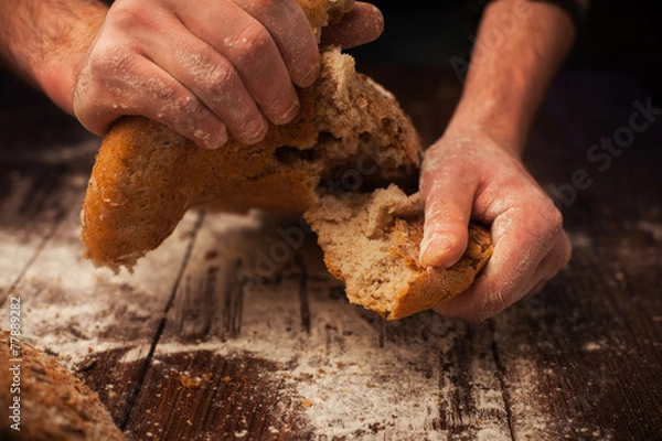 Obraz Baker hands with fresh bread on table