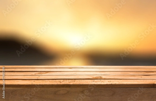 Fototapeta Empty wooden deck table on sunset abstract background.