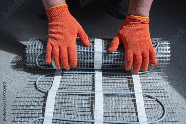 Obraz Instalation of electric underfloor heating mats. Electric floor heating.

