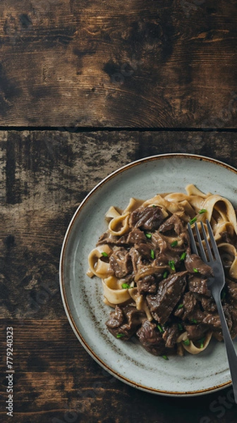 Fototapeta Overhead of beef stroganoff with copy space