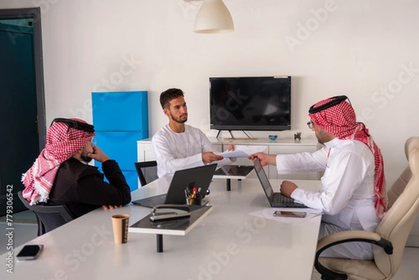 Fototapeta Arab males in meeting during work with copy space