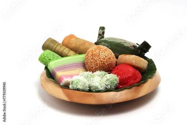 Obraz Various kinds of Jajan Pasar, traditional Indonesian market snacks, on the wooden plate with banana leaves isolated on white background clipping path