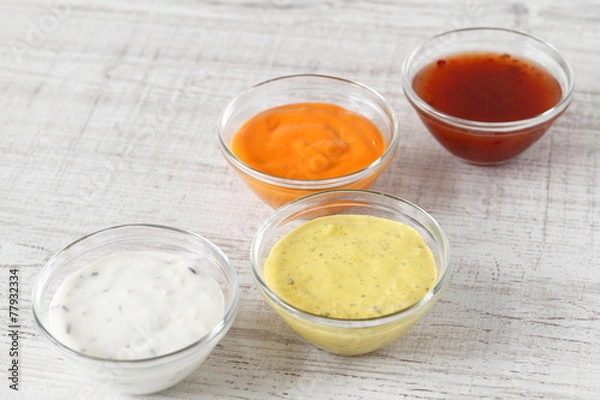 Fototapeta Garlic, chili, curry and cocktail sauce in small bowls