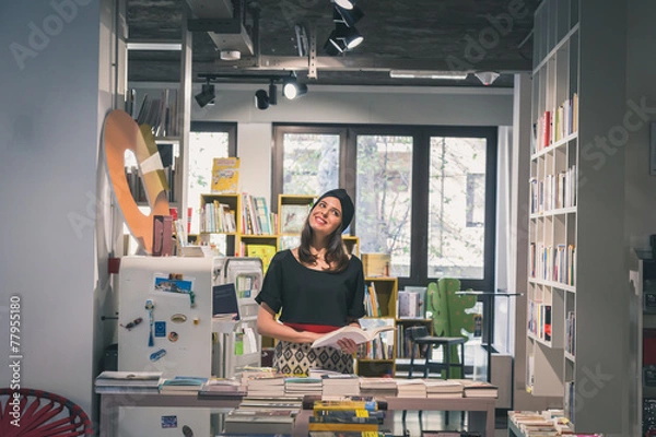 Obraz Beautiful young brunette posing in a bookstore