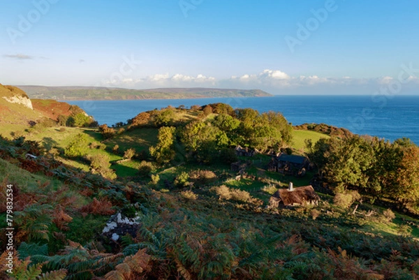 Fototapeta Traditional old irish house on the shores of the atlantic ocean with cloudy sky on sunrise hidden village of galboly europe