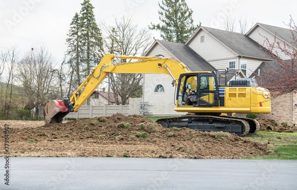 Fototapeta Backhoe Clearing Land for Development