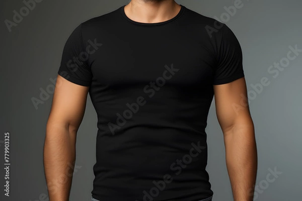 Fototapeta A muscular man in a black t-shirt mock up, viewed from the front isolated on white background
