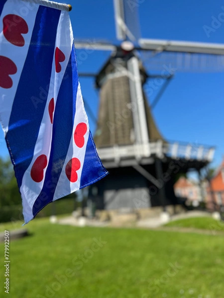 Fototapeta Frisian flag at the windmill in Sloten