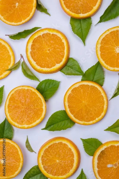 Obraz background with slides of orange and leaves on a white background, trendy summer, fruity background