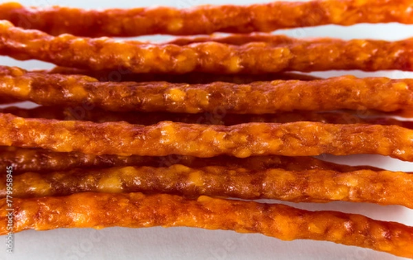 Obraz Many thin sausages on a white background