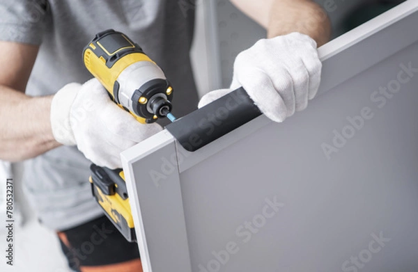 Fototapeta Cabinetmaker with a Drill Driver in His Hand