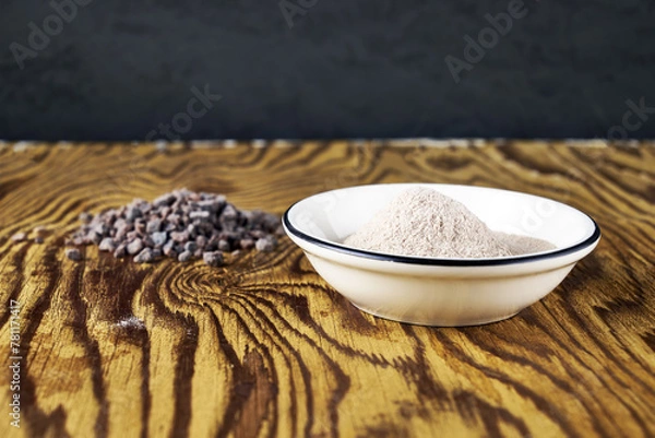 Obraz Black Kala namak salt on a plate and on a wooden table