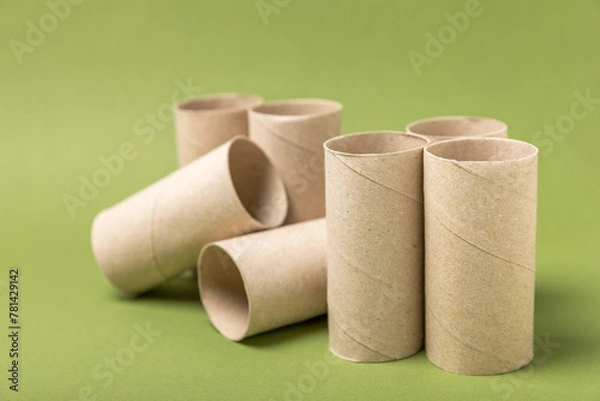 Obraz Empty toilet paper roll. Rolls of toilet paper on a green background. Paper tube of toilet paper. Place for text. Copy space. Flat lay. Eco-friendly reuse recycle