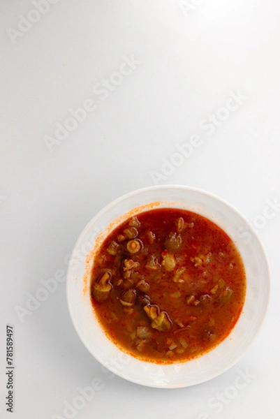Fototapeta Okra soup with meat, white isolated background.
