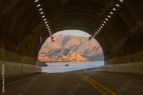Obraz Tunnel exit overlooking Lake Potrerillos at dawn, in Mendoza, Argentina.