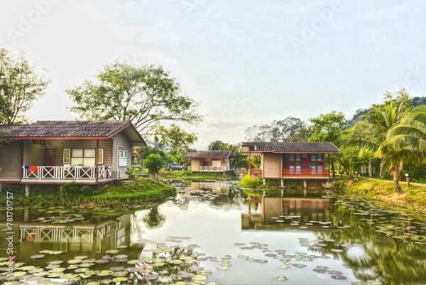 Fototapeta Baan Rim Nam. Beautiful landscape view of three house wooden with reflect shadow on water pond isolated with green nature background. Home traditional design for create to help cool down in summer.