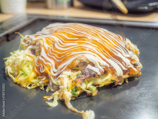 Obraz Okonomiyaki on an iron pan in Japan