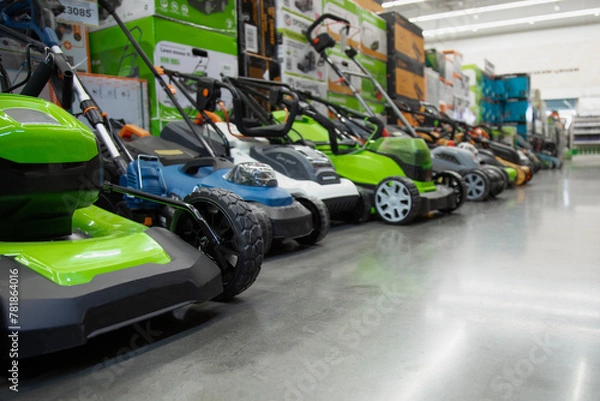 Fototapeta Showcase of the lawn mower in store.  A variety of lawn mowers in the shop of machinery and goods for the garden