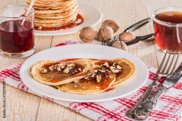 Fototapeta Homemade pancakes with walnuts and strawberry jam