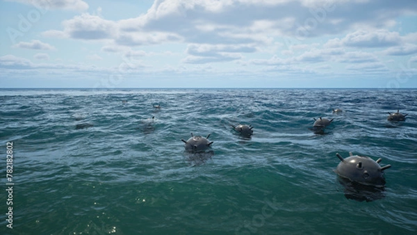 Fototapeta Mines float on the waves in the ocean