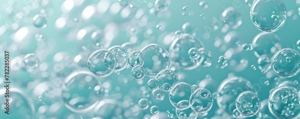 Fototapeta Transparent soap bubbles floating on a teal background